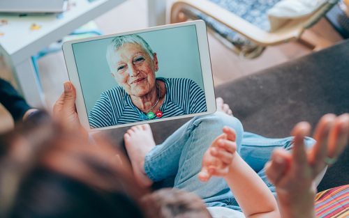 Kids video calling with grandmother on Ipad
